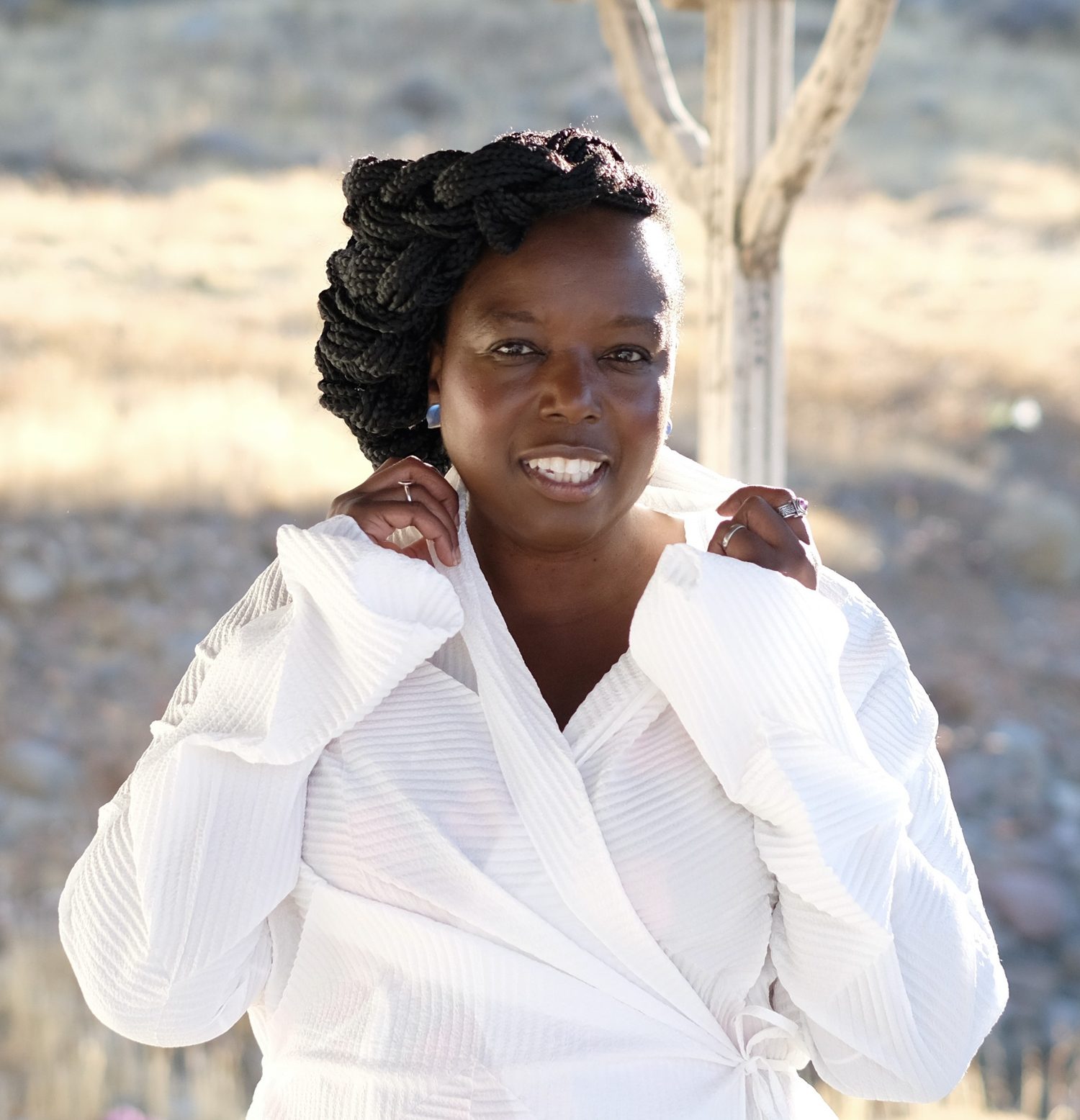 Nadine Benjamin MBE, smiling in a white blouse
